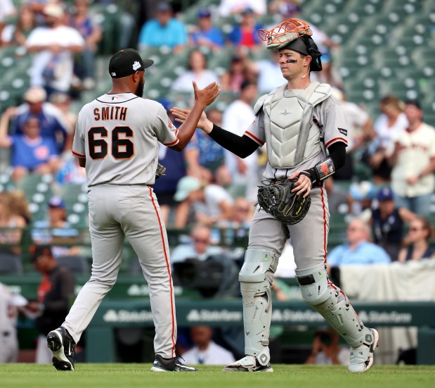 San Francisco Giants relief pitcher Dylan Smith (66) and catcher Daniel Susac (6) celebrate after closing out the Chicago Cubs for a victory at Wrigley Field in Chicago on June 5, 2026. (Chris Sweda/Chicago Tribune)