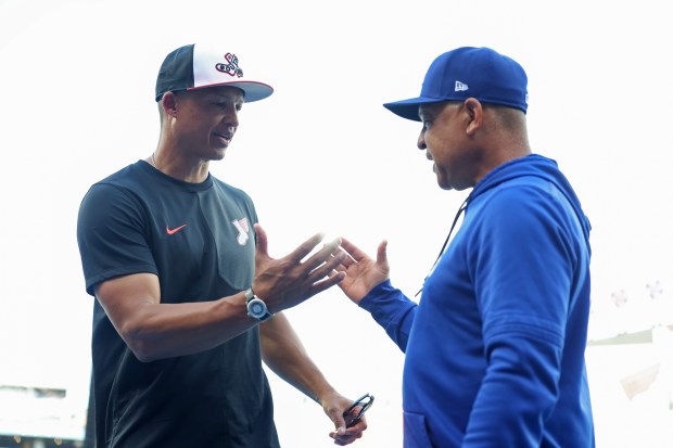 White Sox manager Will Venable, left, and Dodgers manager Dave Roberts finishing a conversation before a game at Rate Field on June 12, 2026, in Chicago. (John J. Kim/Chicago Tribune)