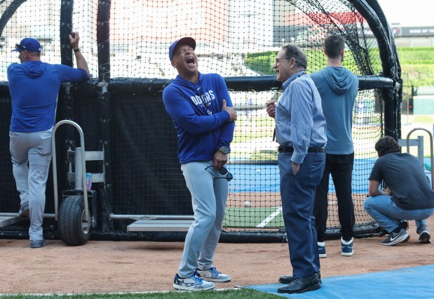 Dodgers manager Dave Roberts, center, laughs while talking with White Sox Chairman Jerry Reinsdorf before a game at Rate Field on June 12, 2026, in Chicago. (John J. Kim/Chicago Tribune)