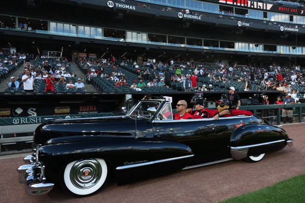 A vintage Cadillac moves through the track during pregame activities for a White Sox-Dodgers game at Rate Field on June 12, 2026, in Chicago. (John J. Kim/Chicago Tribune)