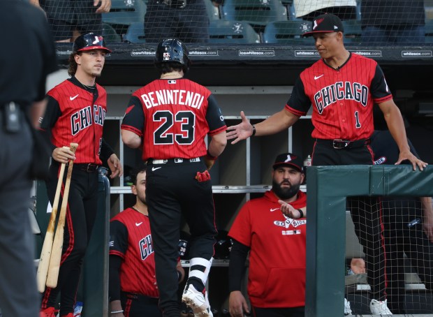 White Sox manager Will Venable, right, congratulates designated hitter Andrew Benintendi after a home run in the first inning against the Dodgers on June 12, 2026, at Rate Field. (John J. Kim/Chicago Tribune)