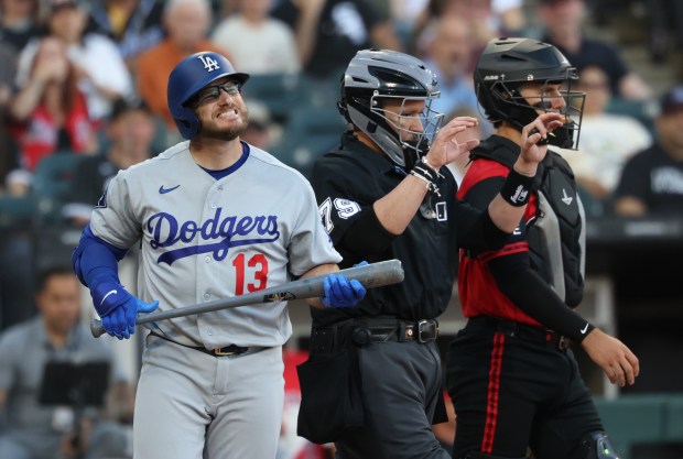 Dodgers third baseman Max Muncy grimaces after being hit by a pitch in the second inning against the White Sox on June 12, 2026, at Rate Field. (John J. Kim/Chicago Tribune)