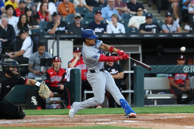 Dodgers designated hitter Santiago Espinal connects for a two-run single in the second inning against the White Sox on June 12, 2026, at Rate Field. (John J. Kim/Chicago Tribune)