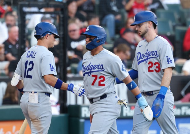 Dodgers shortstop Miguel Rojas (72) and right fielder Kyle Tucker (23) head to the dugout after scoring on a two-run single by designated hitter Santiago Espinal in the second inning against the White Sox on June 12, 2026, at Rate Field. (John J. Kim/Chicago Tribune)
