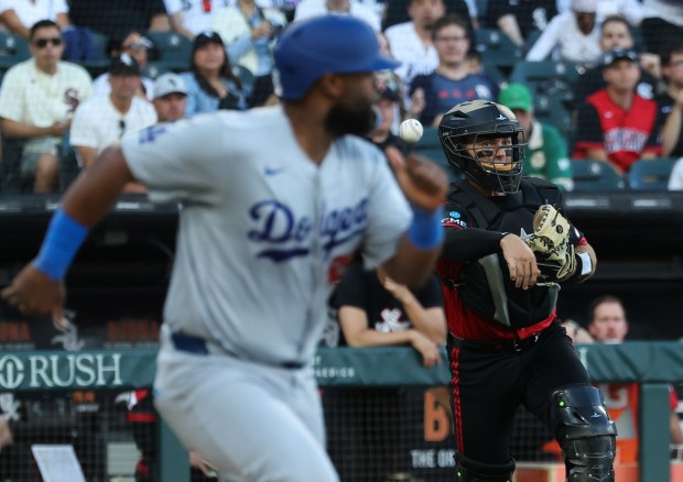 White Sox catcher Drew Romo throws to first base on a sacrifice bunt by Dodgers catcher Chuckie Robinson in the second inning on June 12, 2026, at Rate Field. (John J. Kim/Chicago Tribune)
