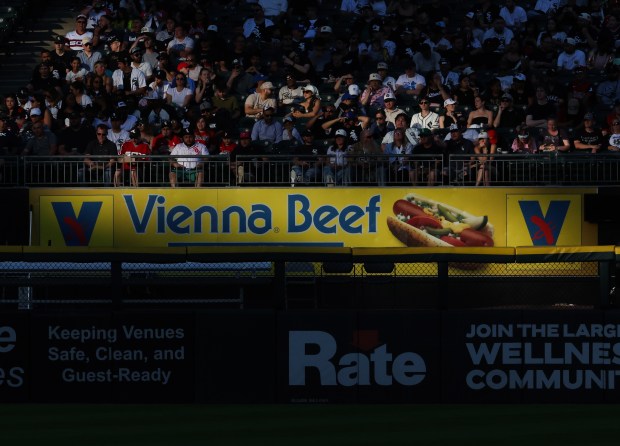 A Vienna Beef advertisement in the bullpen is illuminated by the setting sun in the second inning of a White Sox-Dodgers game at Rate Field on June 12, 2026, in Chicago. (John J. Kim/Chicago Tribune)