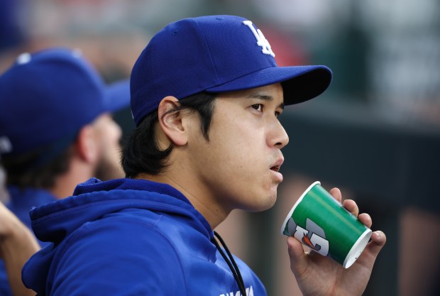 Dodgers star Shohei Ohtani eats sunflower seeds while sitting in the dugout in the third inning against the White Sox on June 12, 2026, at Rate Field. (John J. Kim/Chicago Tribune)
