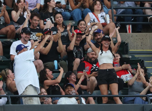 A fan celebrates in the upper deck after catching a foul ball in the fourth inning of a White Sox-Dodgers game on June 12, 2026, at Rate Field. (John J. Kim/Chicago Tribune)