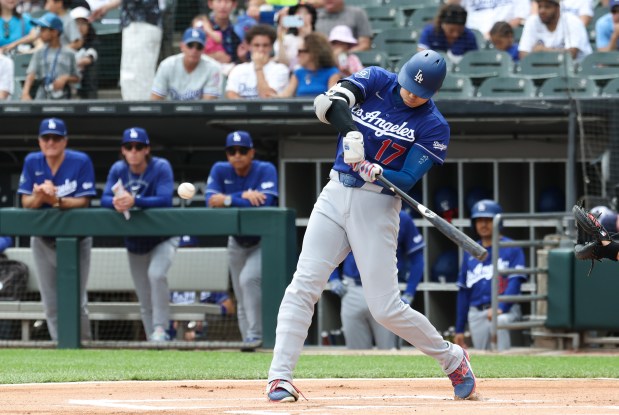 Dodgers designated hitter Shohei Ohtani swings for a home run to lead off the first inning against the White Sox on June 13, 2026, at Rate Field. (John J. Kim/Chicago Tribune)