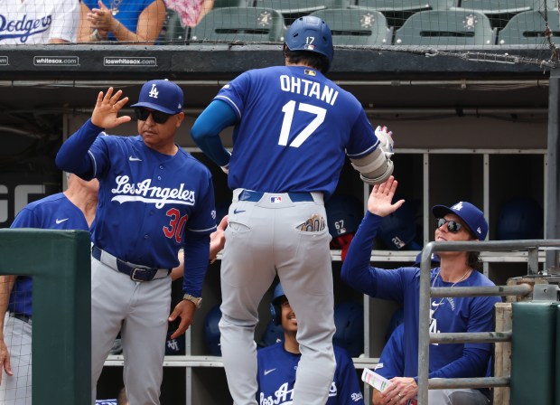 Dodgers designated hitter Shohei Ohtani reaches the dugout after hitting a home run in the first inning against the White Sox on June 13, 2026, at Rate Field. (John J. Kim/Chicago Tribune)