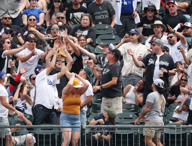Fans reach for a two-run home run ball hit by Dodgers third baseman Max Muncy in the first inning against the White Sox at Rate Field on June 13, 2026, Fans reach for a two-run home run ball hit by Dodgers third baseman Max Muncy in the first inning against the White Sox at Rate Field on June 13, 2026, in Chicago. (John J. Kim/Chicago Tribune. (John J. Kim/Chicago Tribune)