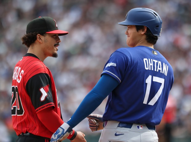 White Sox third baseman Miguel Vargas and Dodgers designated hitter Shohei Ohtani share a light conversation in the fourth inning on June 13, 2026, at Rate Field. (John J. Kim/Chicago Tribune)
