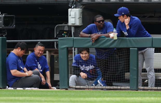 Dodgers designated hitter Shohei Ohtani, center, watches from the dugout in the fourth inning against the White Sox on June 13, 2026, at Rate Field. (John J. Kim/Chicago Tribune)