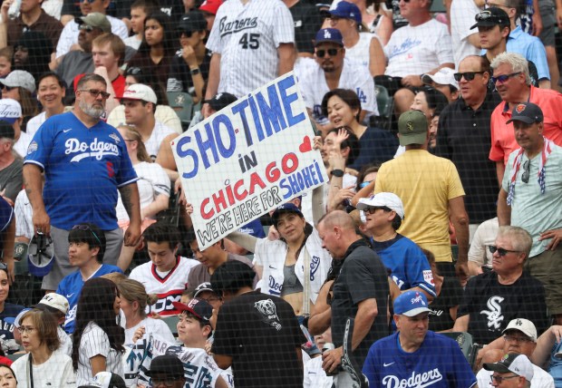A Dodgers fan holds up a sign cheering on designated hitter Shohei Ohtani in the ninth inning against the White Sox on June 13, 2026, at Rate Field. (John J. Kim/Chicago Tribune)