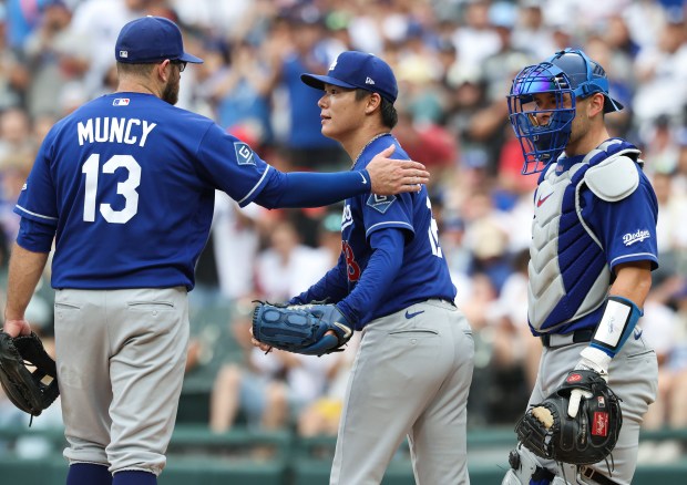Dodgers starter Yoshinobu Yamamoto, center, is congratulated by teammates before being taken out of the game in the ninth inning against the White Sox on June 13, 2026, at Rate Field. Yamamoto pitched a no-hitter into the ninth until he gave up a home run to White Sox center fielder Tristan Peters. (John J. Kim/Chicago Tribune)