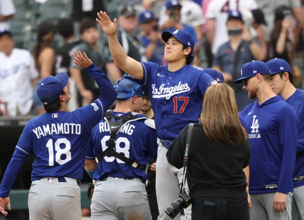 Dodgers designated hitter Shohei Ohtani (17) congratulates starter Yoshinobu Yamamoto on a 7-1 win over the White Sox on June 13, 2026, at Rate Field. (John J. Kim/Chicago Tribune)
