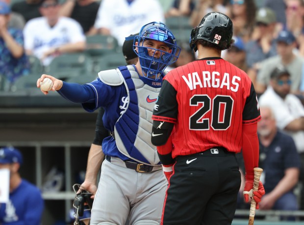 Dodgers catcher Dalton Rushing talks with White Sox third baseman Miguel Vargas while waiting on an ABS challenge call in the seventh inning on June 13, 2026, at Rate Field. (John J. Kim/Chicago Tribune)
