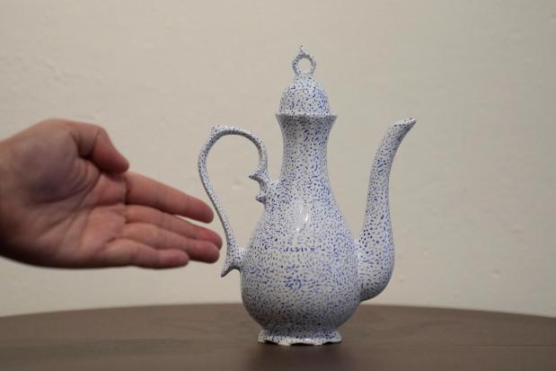 OUT Museum founder Xiangqi Chen gestures toward porcelain artwork by artist Dixon Ngai displayed at the Chinatown museum, Monday, June 22, 2026, in San Francisco. (AP Photo/Jeff Chiu)