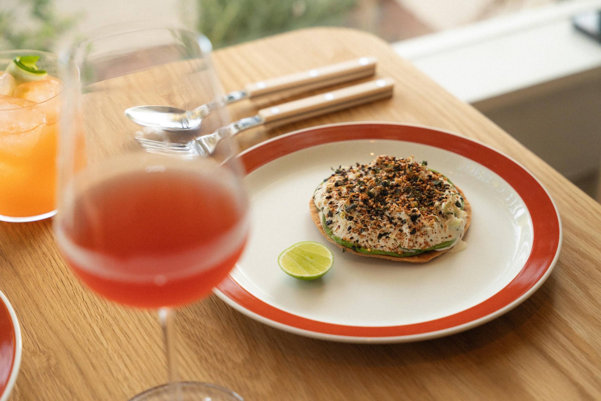 Crab tostada with wine in the foreground at San Damian.