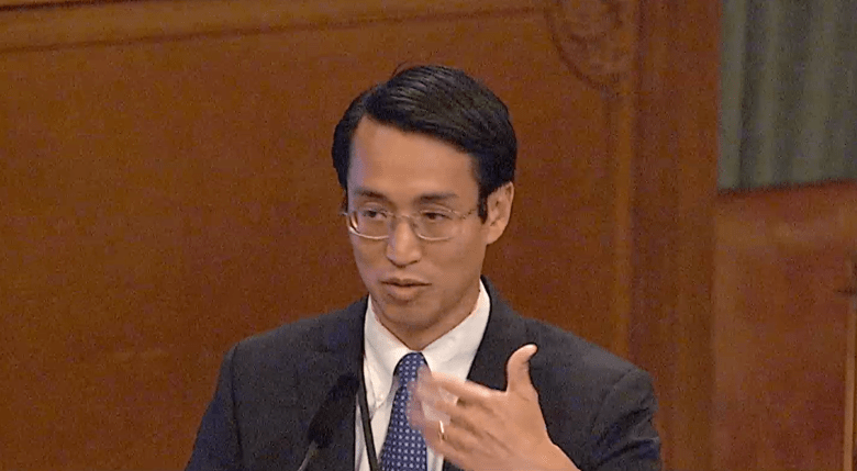 Daniel Tsai in suit and tie in a meeting room