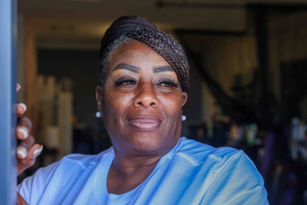 Oakland mayoral candidate Brenda Grisham looks out from her beauty shop at the International Plaza, a former motel converted into commercial spaces at the corner of International Boulevard and 17th Avenue in Oakland, Calif., on Friday, April 17, 2026. (Ray Chavez/Bay Area News Group)