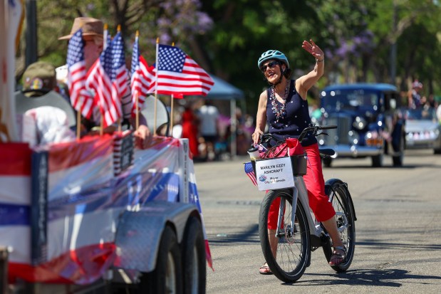 Alameda Mayor Marilyn Ezzy Ashcraft rides a bike as she waves at the crowd during the annual Fourth of July Parade in Alameda, Calif., on Thursday, July 4, 2024. (Ray Chavez/Bay Area News Group)
