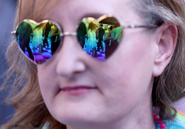 Dancers are reflected in Erin Johnson's glasses during the BART Prom at the Rockridge BART station Oakland, Calif., on Saturday, June 6, 2026. The first-ever event had an 1980's and under-the-sea theme and sold out. (Jane Tyska/Bay Area News Group)