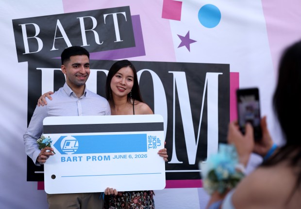 Couples have their photo taken during the BART Prom at the Rockridge BART station Oakland, Calif., on Saturday, June 6, 2026. The first-ever event had an 1980's and under-the-sea theme and sold out. (Jane Tyska/Bay Area News Group)