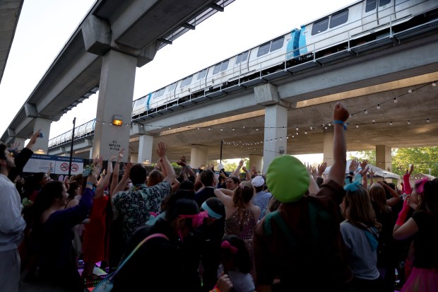 People cheer as a BART train passes during the BART Prom at the Rockridge BART station Oakland, Calif., on Saturday, June 6, 2026. The first-ever event had an 1980's and under-the-sea theme and sold out. (Jane Tyska/Bay Area News Group)