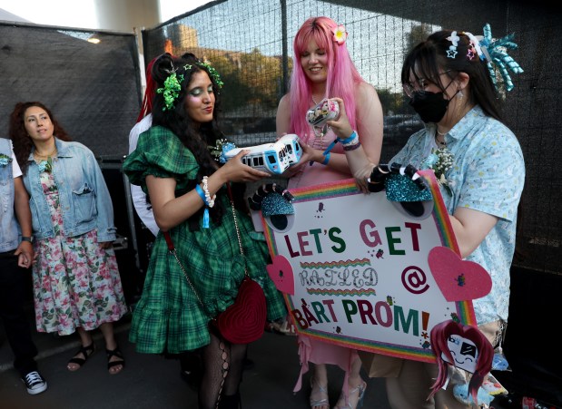 Ameya Patkar, ​Shannelle Craig and Estella Lin, of Cupertino, from left, attend the BART Prom at the Rockridge BART station Oakland, Calif., on Saturday, June 6, 2026. The first-ever event had an 1980's and under-the-sea theme and sold out. (Jane Tyska/Bay Area News Group)