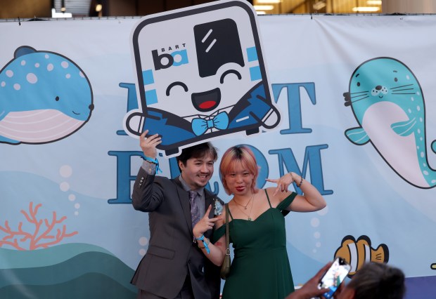 Joseph Baran, of Oakland, and Ellie Ho, of San Francisco, pose for photos during the BART Prom at the Rockridge BART station Oakland, Calif., on Saturday, June 6, 2026. The first-ever event had an 1980's and under-the-sea theme and sold out. (Jane Tyska/Bay Area News Group)