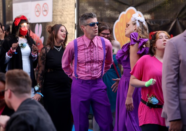 Corbett Simon and Maril Wright, to his right, of Oakland, wait in line to have their photo taken during the BART Prom at the Rockridge BART station Oakland, Calif., on Saturday, June 6, 2026. The first-ever event had an 1980's and under-the-sea theme and sold out. (Jane Tyska/Bay Area News Group)