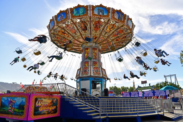 Visitors go for a ride on the Wave Swinger during the Alameda County Fair in Pleasanton, Calif., on Friday, June 13, 2025. The fair goes from June 13th to July 6th. (Jose Carlos Fajardo/Bay Area News Group)