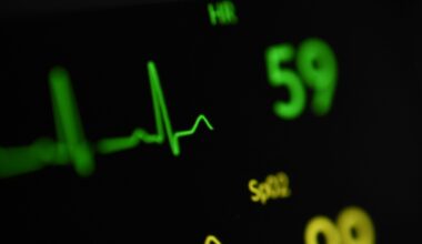 A close-up photo showing an EKG line, with a spike up and wavy lines after, adjacent to numbers showing heart rate.