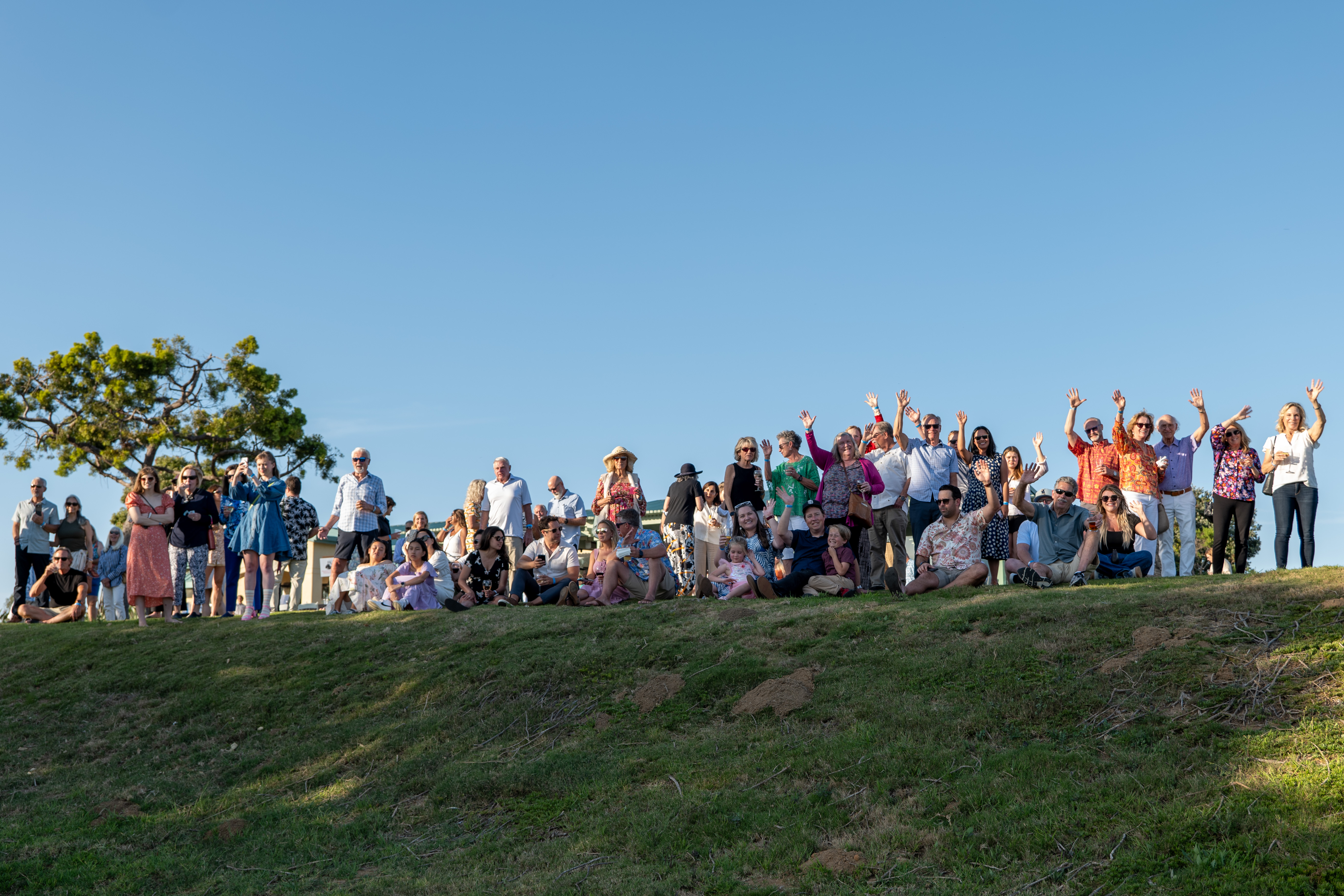 Guests gather along the fairway to watch the helicopter drop...
