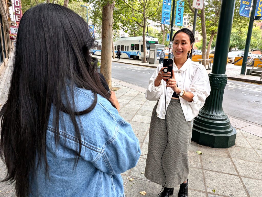 Woman recording an interview on the street