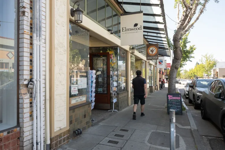 A person walks past stores on College Avenue in Berkeley's Elmwood district