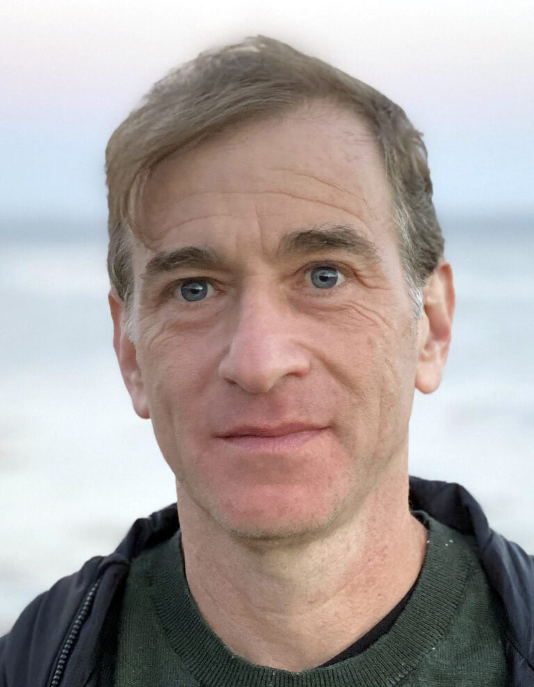 headshot of man looking at camera