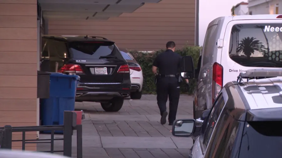 LAPD officers and patrol vehicles outside a residential property on North Detroit Street in Los Angeles following a reported armed home invasion robbery in June 2026.