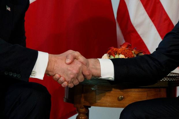 FILE - President Donald Trump shakes hands with French President Emmanuel Macron during a meeting at the U.S. Embassy, May 25, 2017, in Brussels. (AP Photo/Evan Vucci, file)