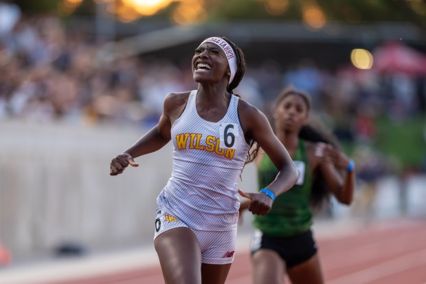 Wilson junior Clara Adams celebrates after winning her second gold medal, in the girls 200 meters, following her win in the 400 meters earlier in the meet. (Photo by John Napalan)