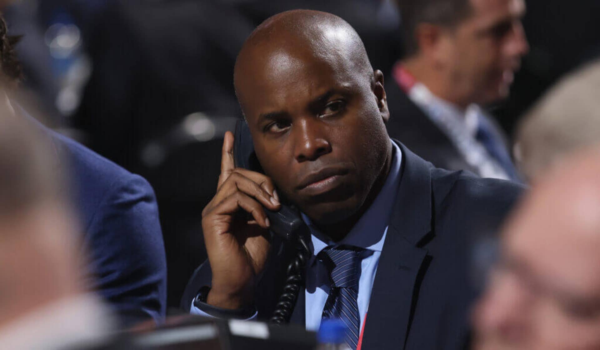 Sharks GM Mike Grier on the phone at the 2022 NHL Draft.