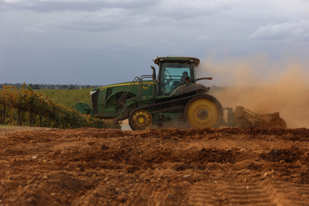 A tractor berms soil for almond trees on a farm near Lodi, Calif., on Oct. 13, 2025. Credit: Patrick T. Fallon/AFP via Getty Images