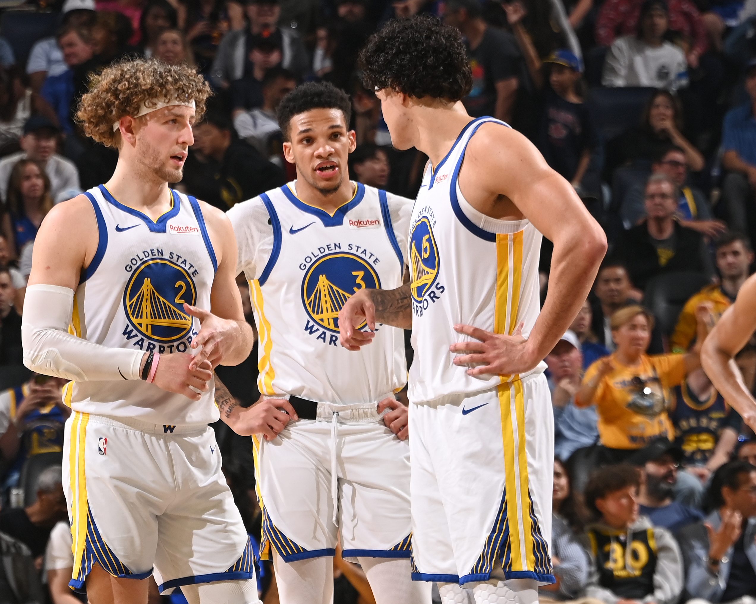 Four Golden State Warriors players on the court during a game.