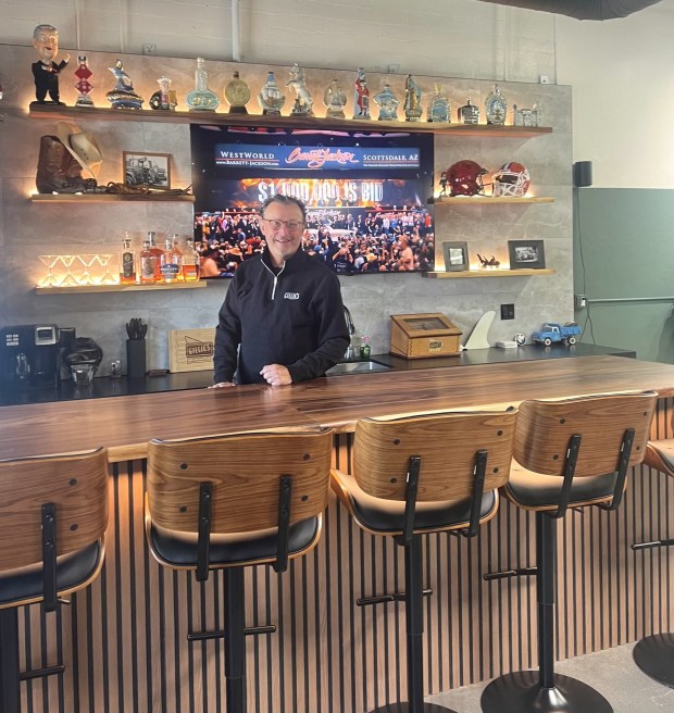 Owner Michael Olguin shows the bar at Gillie's Auto Lounge, featuring a TV, cold drinks, beer and wine and a collection of vintage Jim Beam bourbon bottles. (Provided by Alysa Rodriguez)