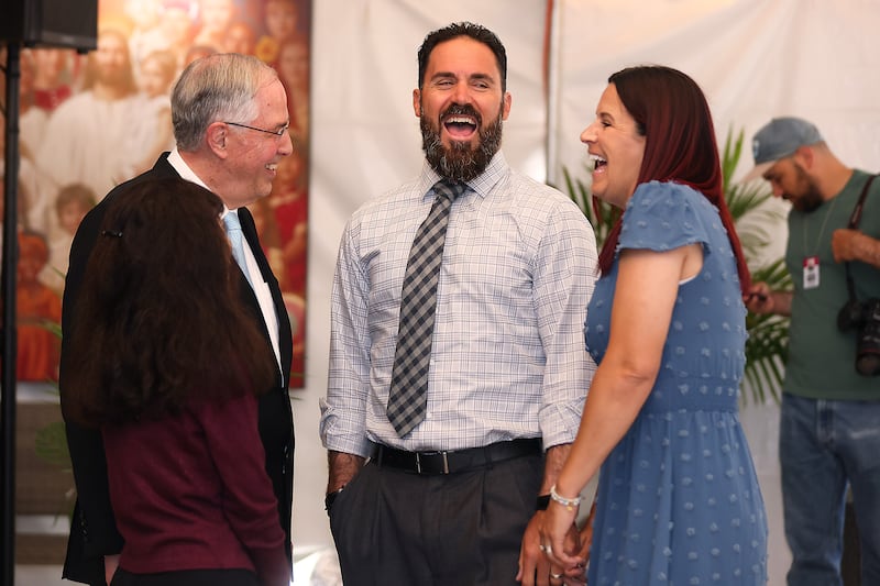Elder Neil L. Andersen speaks to Eric Weddle and Chanel Weddle during the media day of the San Diego California Temple open house on Monday, June 15, 2026.