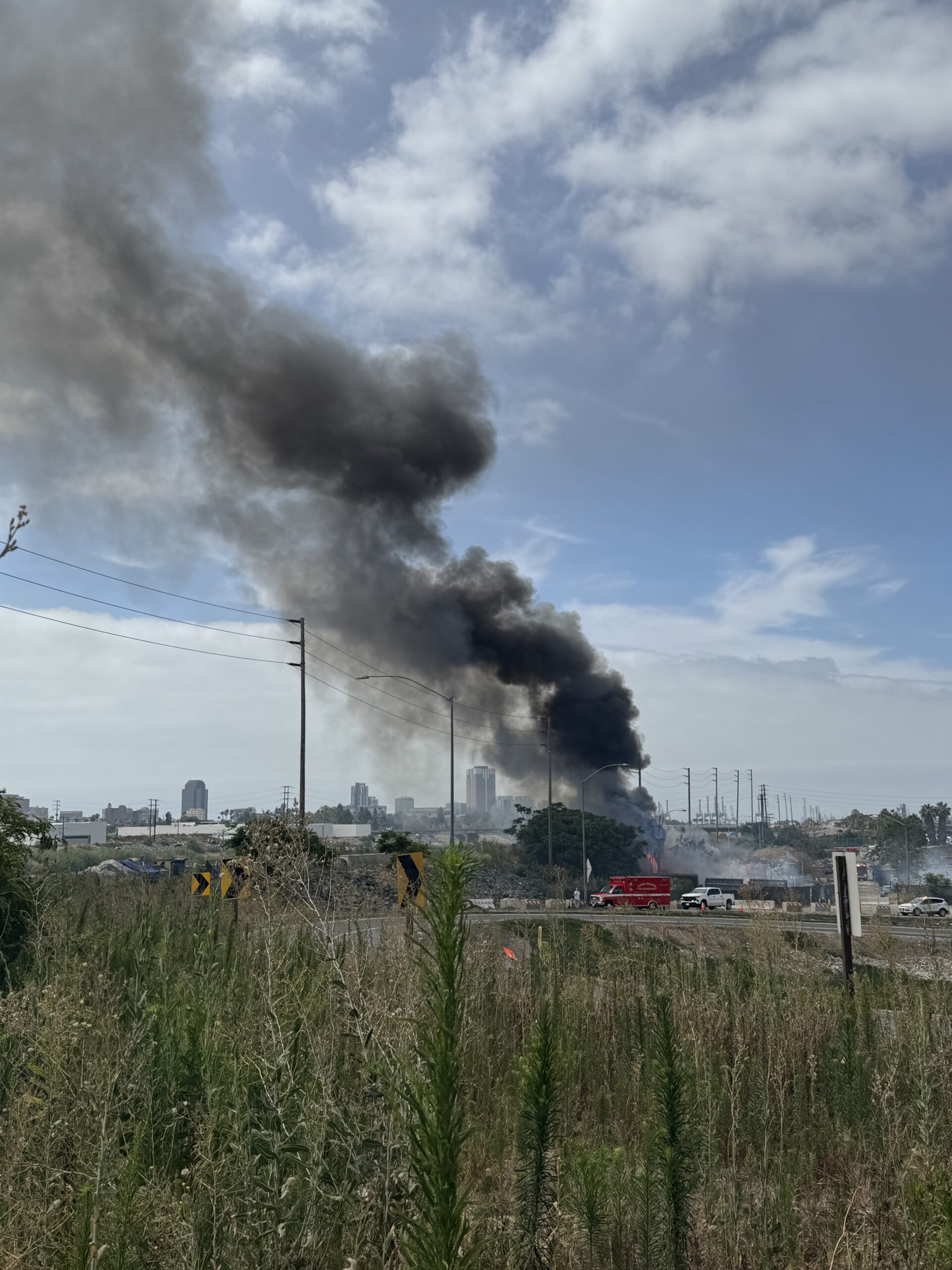 Large Trash Fire Near L.A. River Homeless Encampment Sends Smoke Across Long Beach