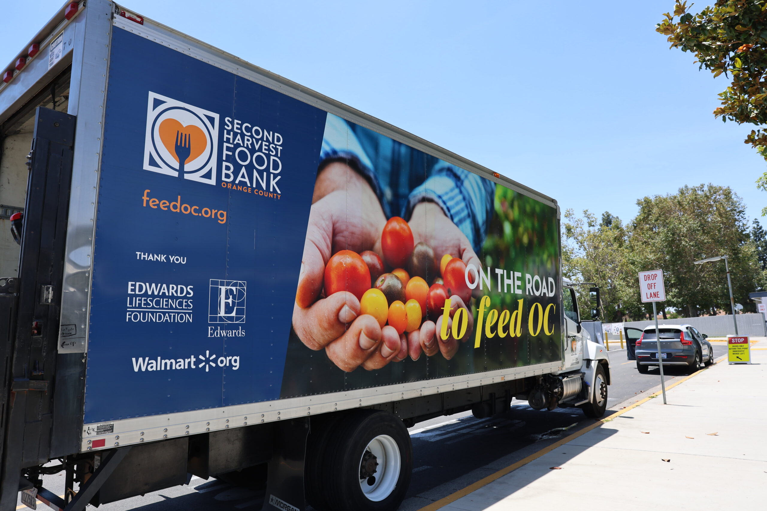 A truck from Second Harvest Food Bank of Orange County delivers food to the Dolphin Food Market at Pacific Drive Elementary School in Fullerton.
