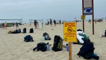 Signs warning people to stay out of the water were posted near the volleyball area on Coronado Beach, Saturday, June 6, 2026.