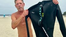 Jason Papa, shows the wet suit he wears to keep warm while swimming in the Pacific Ocean, Coronado, Calif., June 6, 2026